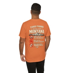 Montana Rules Tee - “3 Things You Don’t Do in Montana: Don’t Pet the Buffalo, Outdrink Canadians, Mess with Cowboy Music”
