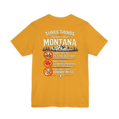 Montana Rules Tee - “3 Things You Don’t Do in Montana: Don’t Pet the Buffalo, Outdrink Canadians, Mess with Cowboy Music”